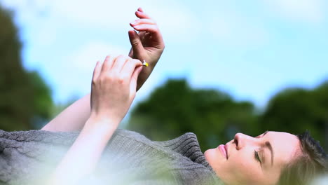 Woman-picking-out-petals-of-a-daisy-flower