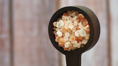 himalayan pink salt in wooden spoon