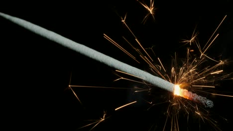 christian sparklers, bengal lights on black background. firework sparkler burning on dark background. closeup