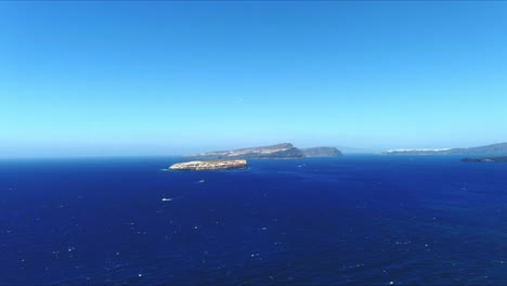 aerial 4k blue sea and sky top view over akrotiri santorini greece with birds flying