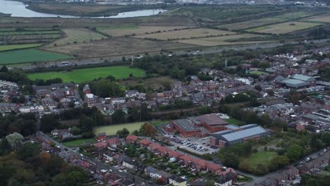 agricultural industry farming landscape motorway power station aerial view tilting to residential area below