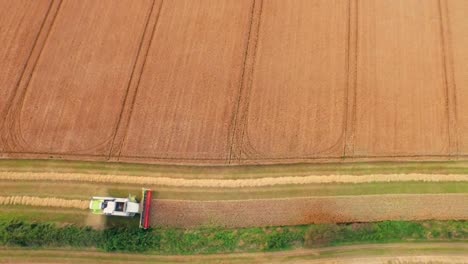 Drone-footage-of-golden-fields-and-combine-harvester