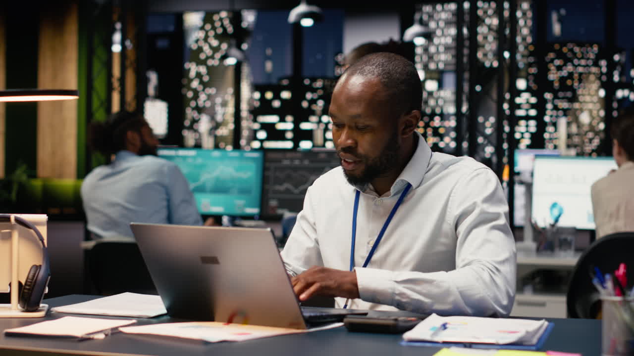 African american businessman in office doing research on laptop
