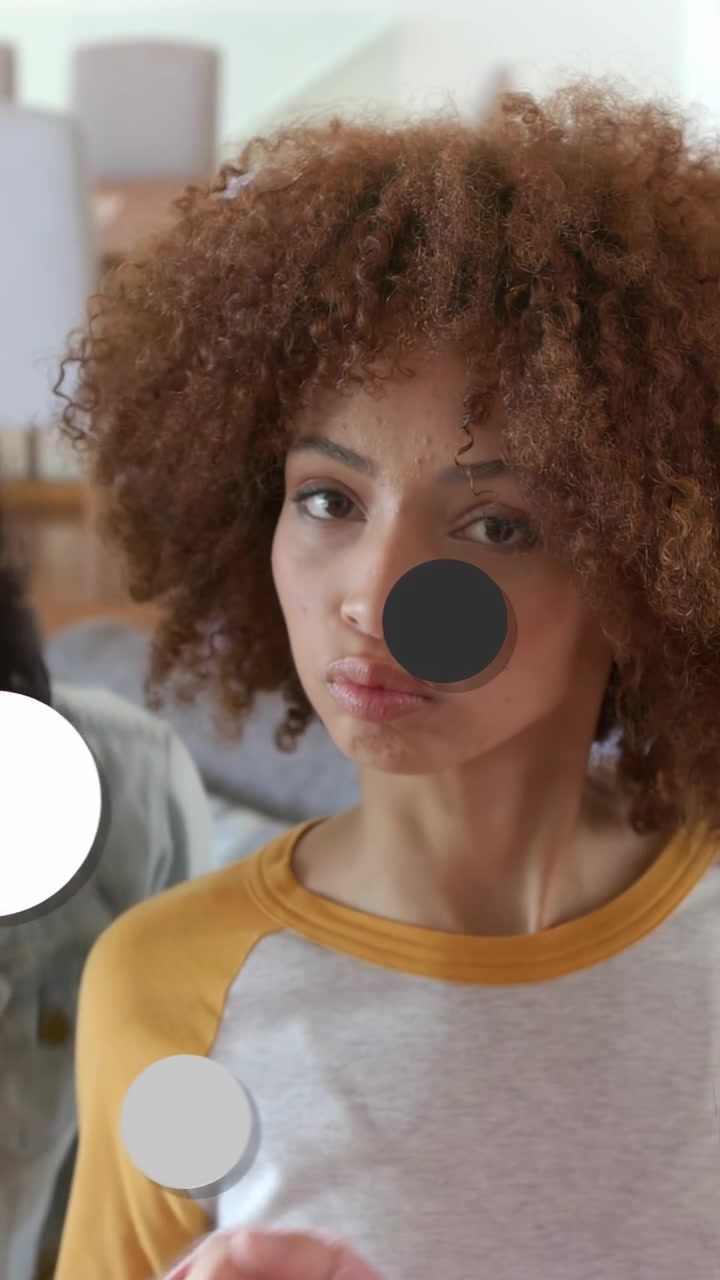 Vertical video: Woman blinking and tilting after flash sending shapes covering face for marketing