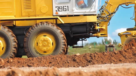 motor grader leveling ground. construction site machinery