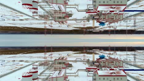 drone flight over the power plant in winter. industry in low temperatures in the north. getting electricity in cold northern countries. efet of reflection of the double world. mirror effect from above