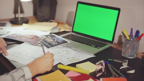 architect working on house plans at desk