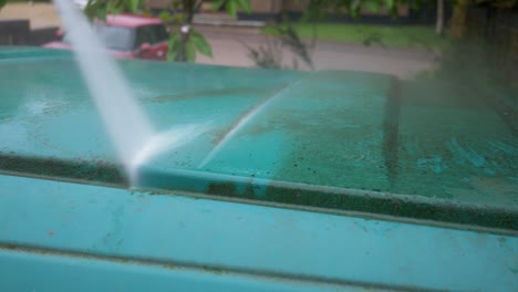 Pressure-washing-and-cleaning-dirt-off-van-roof