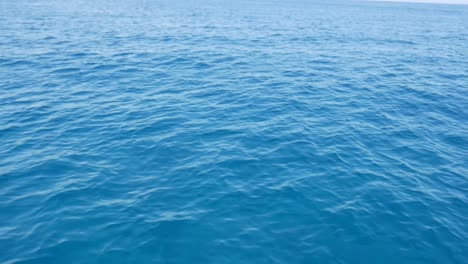 low angle view of moving over open waters of a beautiful blue sea