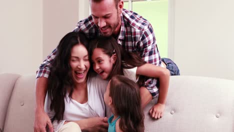 Happy-family-playing-on-sofa-