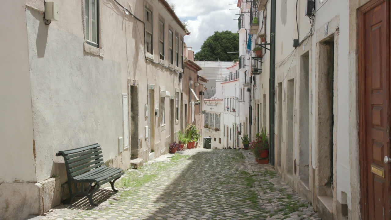 A quiet narrow alleyway in Alfama, one of the oldest neighborhoods in Lisbon, Portugal
