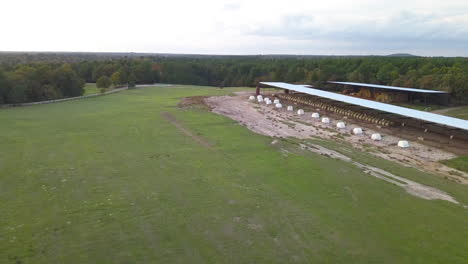 drone shot of a dairy farm with bales of hay