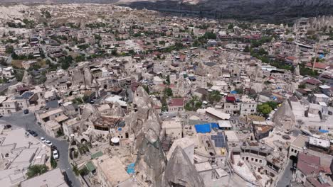 establishing aerial dolly above cappadocia turkey at midday with cloud shadow on stone spires