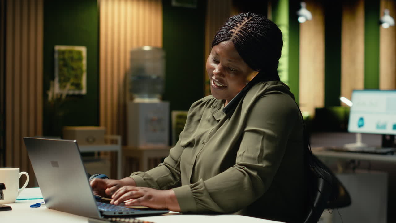 General manager answering a phone call at the office late at night