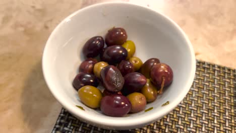 hand picking olives with olive oil and garlic, a typical portuguese snack