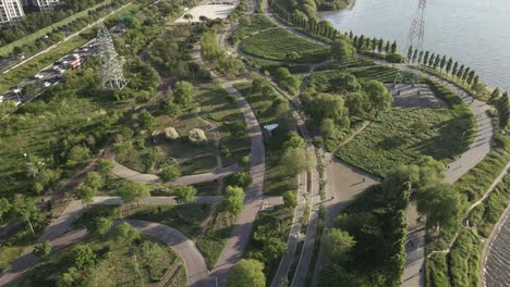 Aerial-flyover-of-green-community-park-in-Seoul-city,-South-Korea