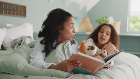 African mother, child and reading book in bed