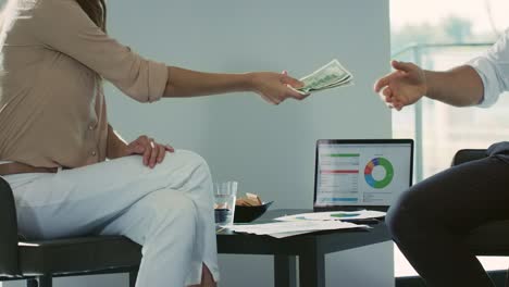 closeup hands counting money in luxury house. businessman taking wad of cash.