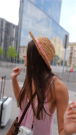 woman with straw hat in urban setting