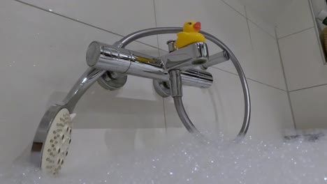 yellow rubber duck on the water tap.
