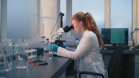 scientist using a microscope in a laboratory