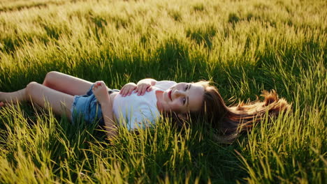young woman enjoying the golden hour in a grassy field