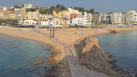 Beautiful-Mediterranean-city-of-white-fishermen's-houses,-blue,-turquoise-water,-yellow-sand-beach,-blue-summer-sky