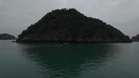 boat view cruising around ha long bay, lan ha bay in vietnam among islands of karst mountains in emerald waters
