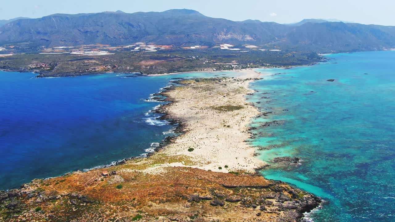 Spectacular view of Elafonisi lagoon, Crete, Greece showing natural pink sand beach with sandbar of shallow waters. Birds eye view. Aerial