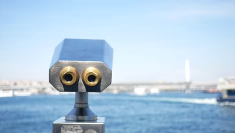 Binoculars on a pier overlooking a harbor