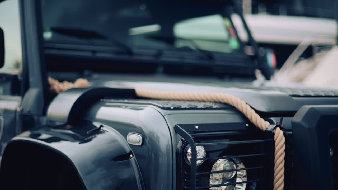 Close up of a rugged off road vehicle with a thick rope across its hood