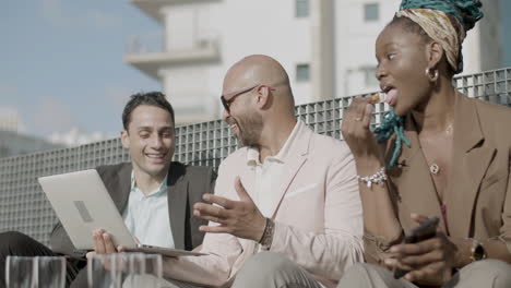 slider shot of coworkers having business party in rooftop cafe