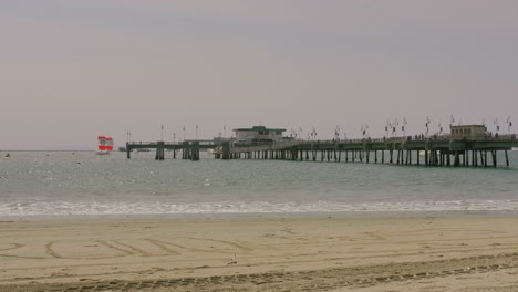 pier on a sunny day with sailboats