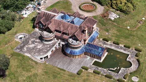 luxurious unfinished celebrity mansion aerial view overlooking rundown private residence gardens
