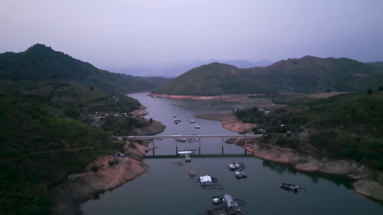 Aerial View of a River, Bridge, and Mountains