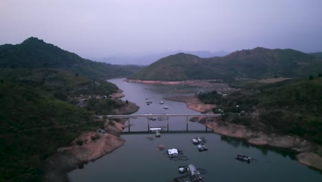 aerial view of a river, bridge, and mountains