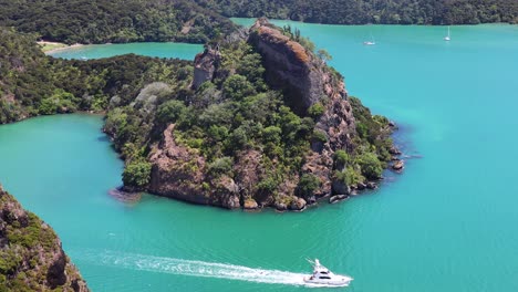 beautiful wide shot from top of kairara rock of yacht sailing on beautiful blue sea