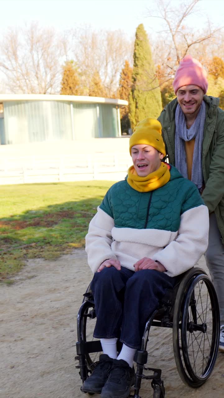 Man Pushing Woman in Wheelchair Through Autumn Park