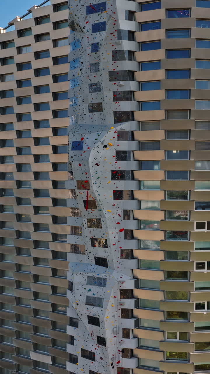 Aerial drone view of CopenHill artificial ski slope on the roof of an energy plant. Vertical