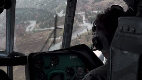 helicopter pilot's cockpit view over scenic landscape