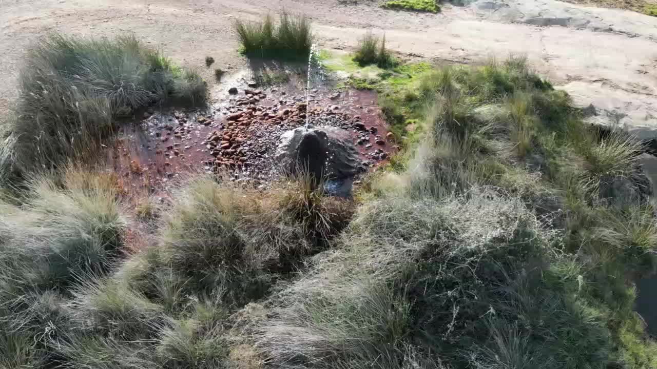 Hot water geyser at Fuendejalon Spain with water and iron deposits.
