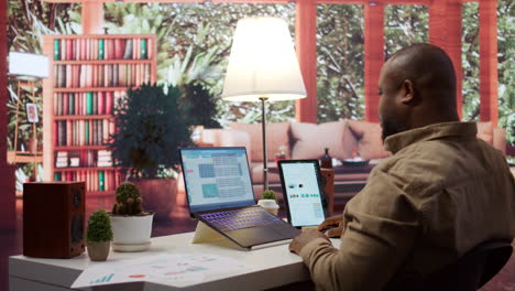 entrepreneur calculating expenses with online invoices on laptop