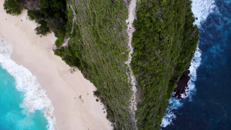 kelingking beach on nusa penida island, breathtaking top down aerial drone view