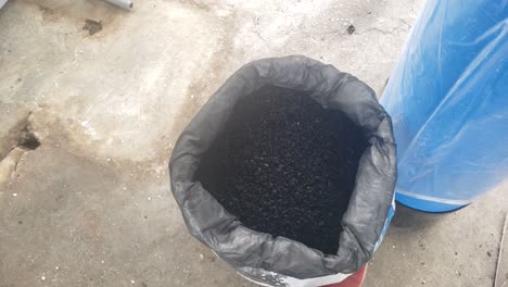 big ro vessel tank with black coal in sack or coal bag