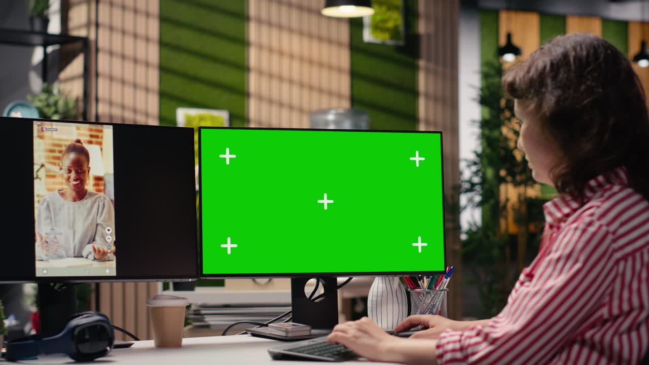 Woman Working on Computer with Green Screen Monitor in Office