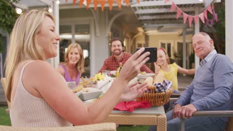 Familia-De-Tres-Generaciones-Tomándose-Un-Selfie-Mientras-Disfruta-De-Un-Almuerzo-Al-Aire-Libre