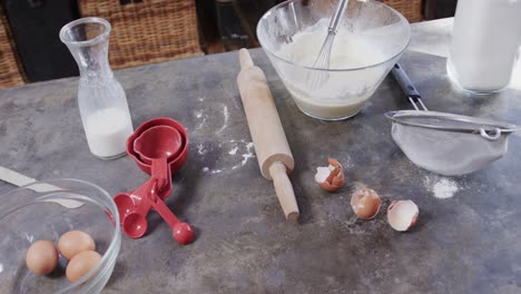 close up of flour, milk and eggs on worktop in kitchen, slow motion