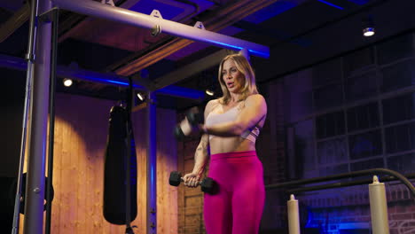 sport woman working out with dumbbells in the gym - close up