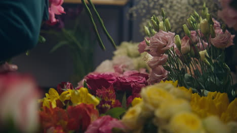 male florist collects bouquet for customer vertical shot