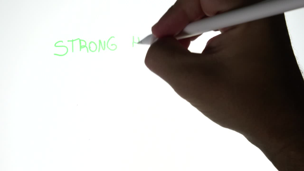Person writing in a tablet strong hands never sell and a bitcoin symbol